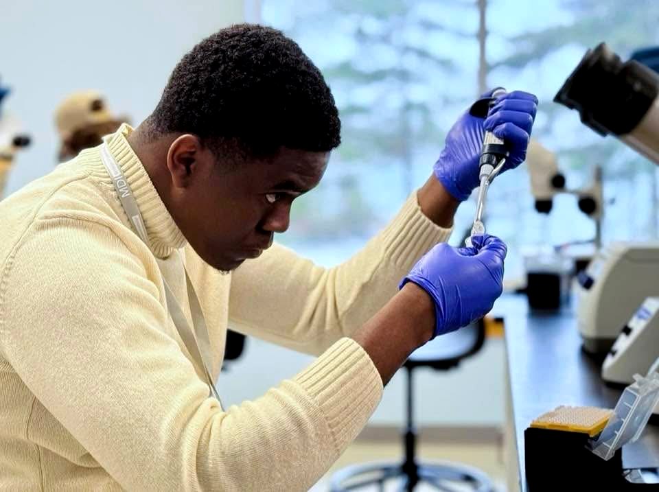 Doxel Tanzey pipetting at the bench, MDI Biological Laboratory